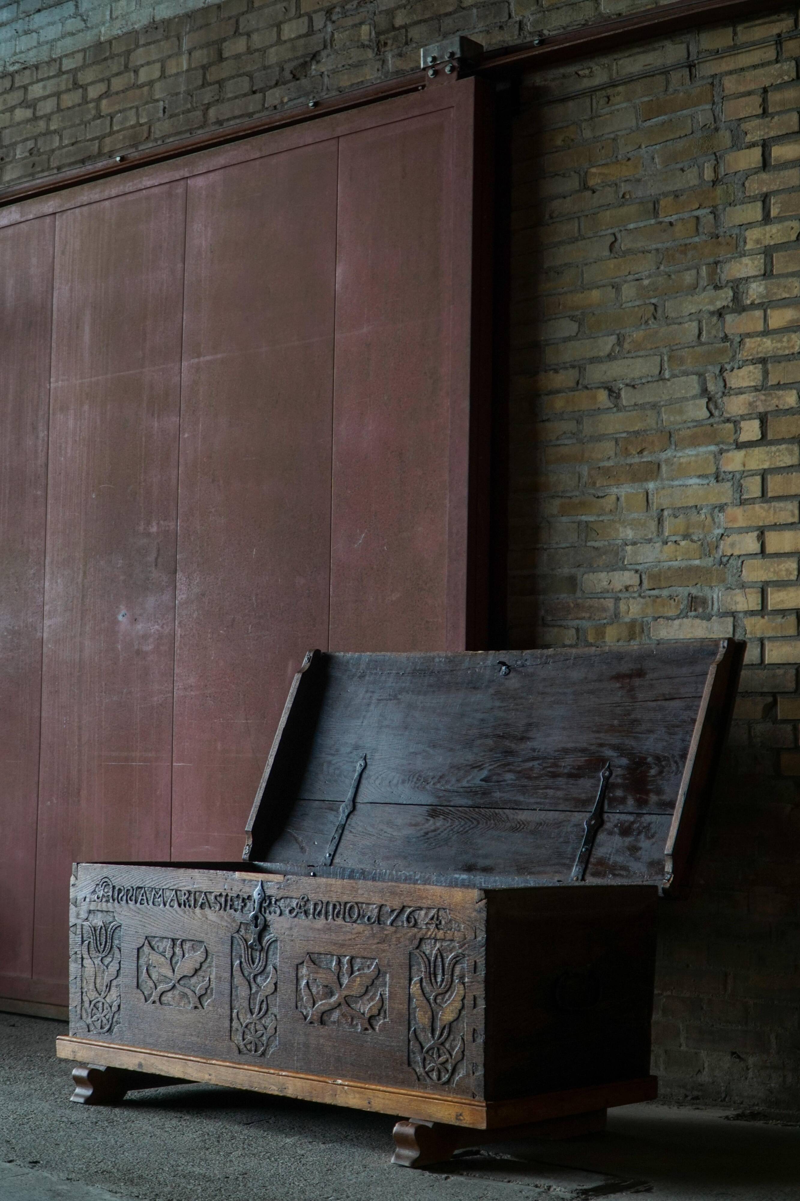 18th-century Scandinavian popular art oak chest with carved panels, dated 1764.