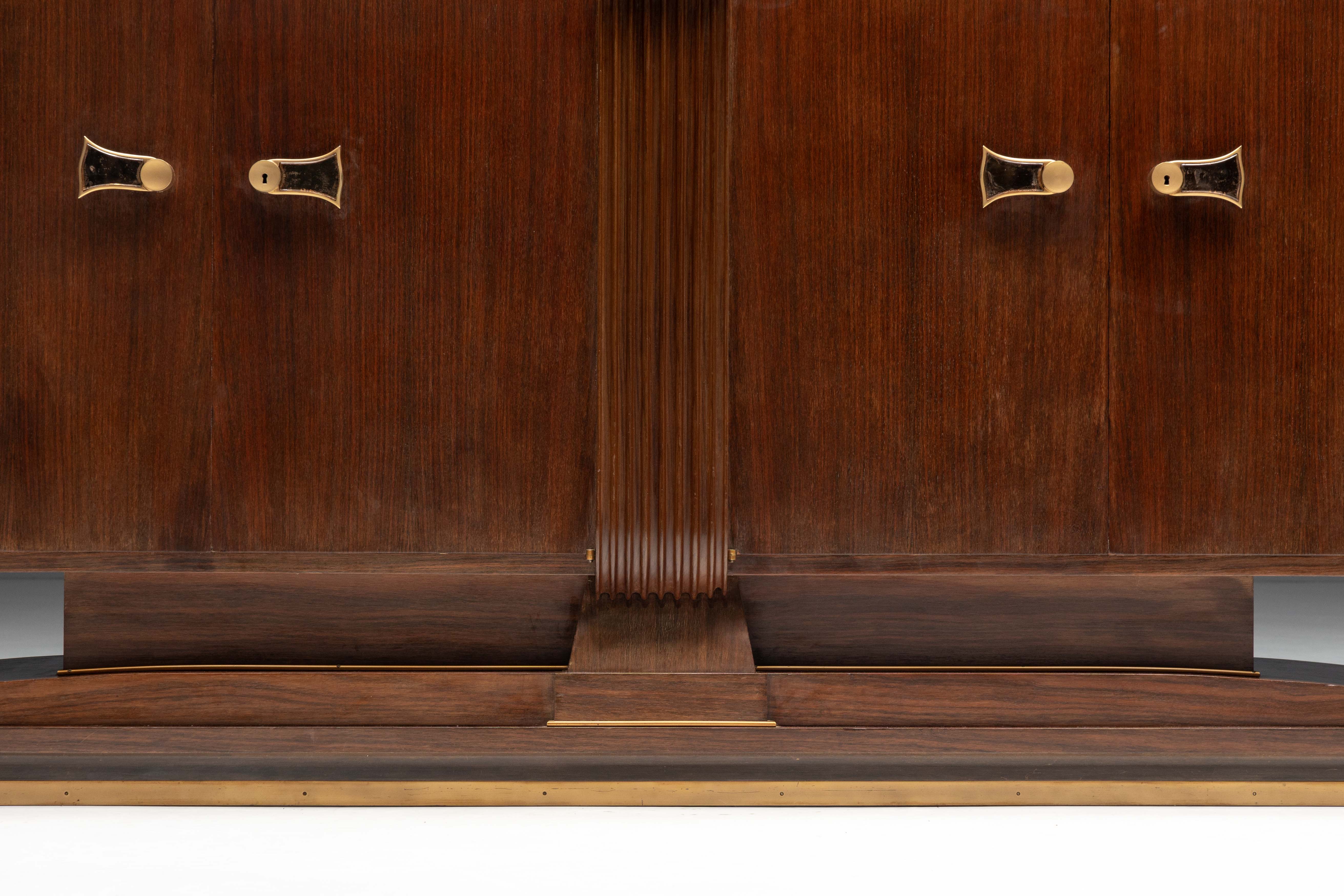 Art Deco walnut sideboard with brass details and sculptural base, France, 1930s