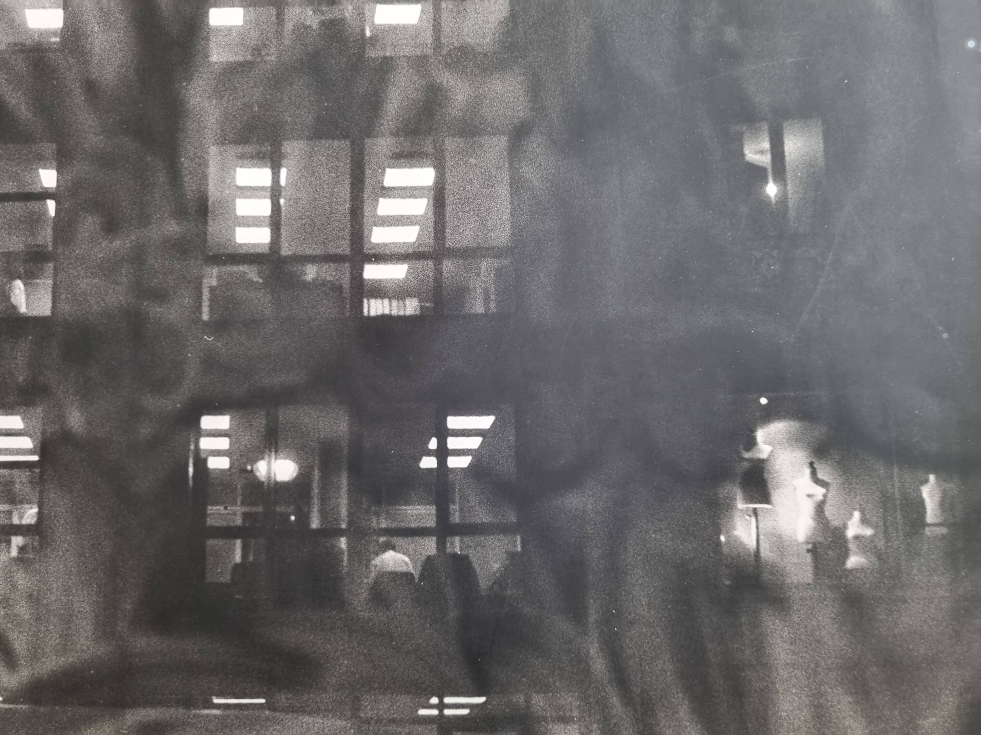 Framed black and white photograph of an urban scene by Rosine Nucimovici, 52x42 cm.