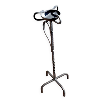 Old ashtray on twisted hammered wrought iron legs, vintage decor.