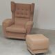 Beige wingback armchair and TVAR footrest, former Czechoslovakia.