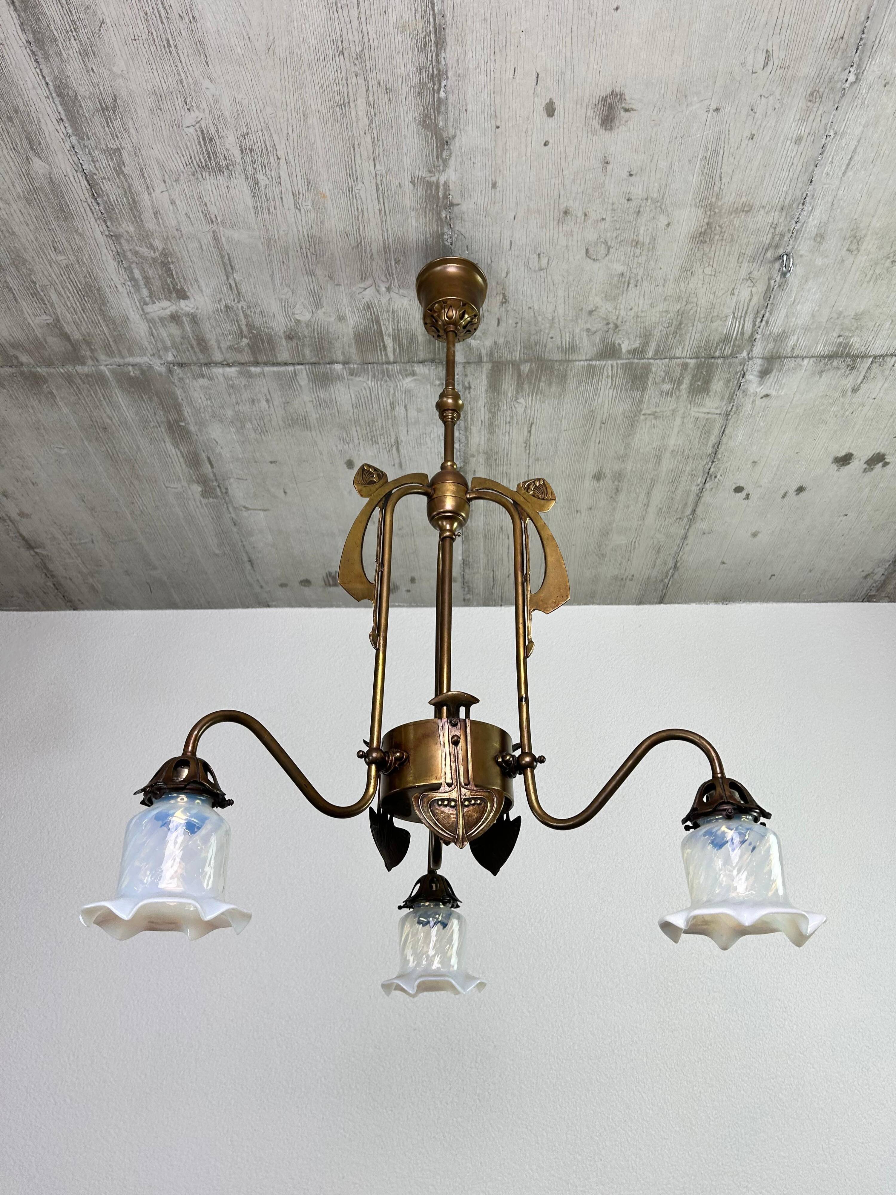 Art Nouveau chandelier with three arms and opalescent iridescent glass.