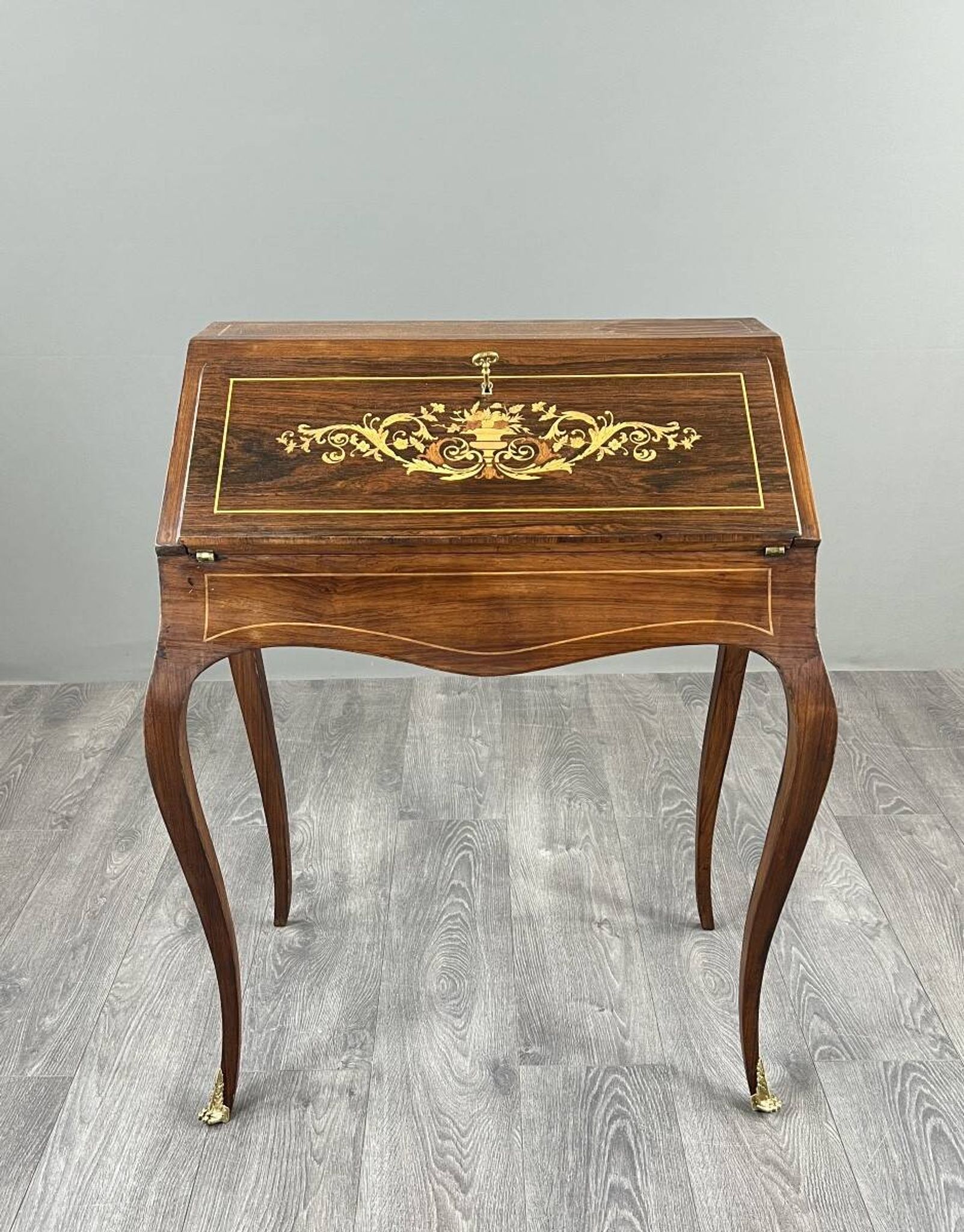 Secretary with a drop-down front in marquetry, Louis XV style, 19th century.