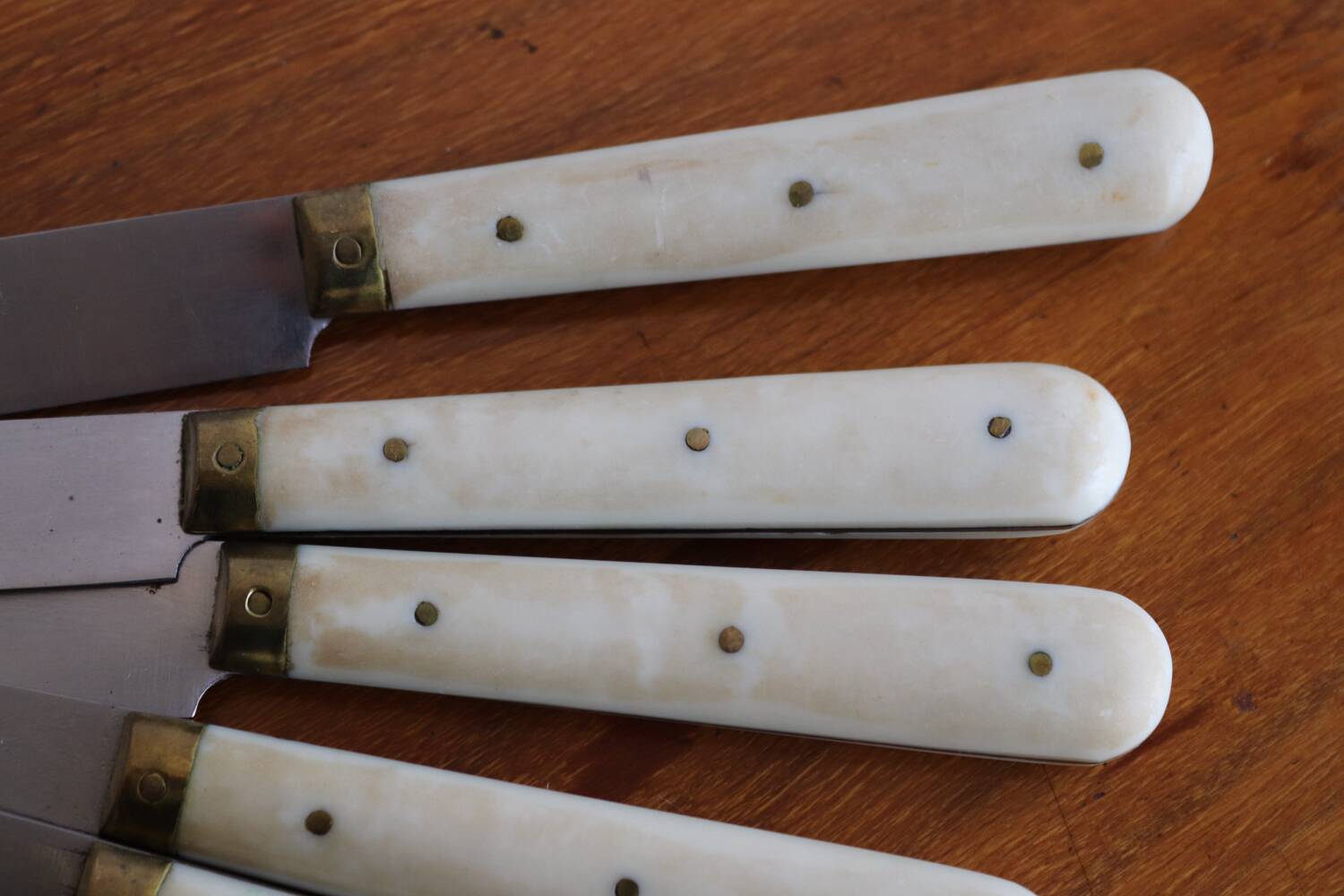 Set of 9 vintage cream table knives