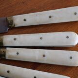 Set of 9 vintage cream table knives