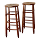 Antique wooden bar stool with a straw seat