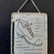Old illustration "Exterior of a shoe" inserted under mirror