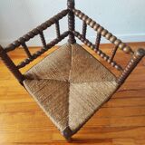 Antique corner chair made of turned wood spindle.