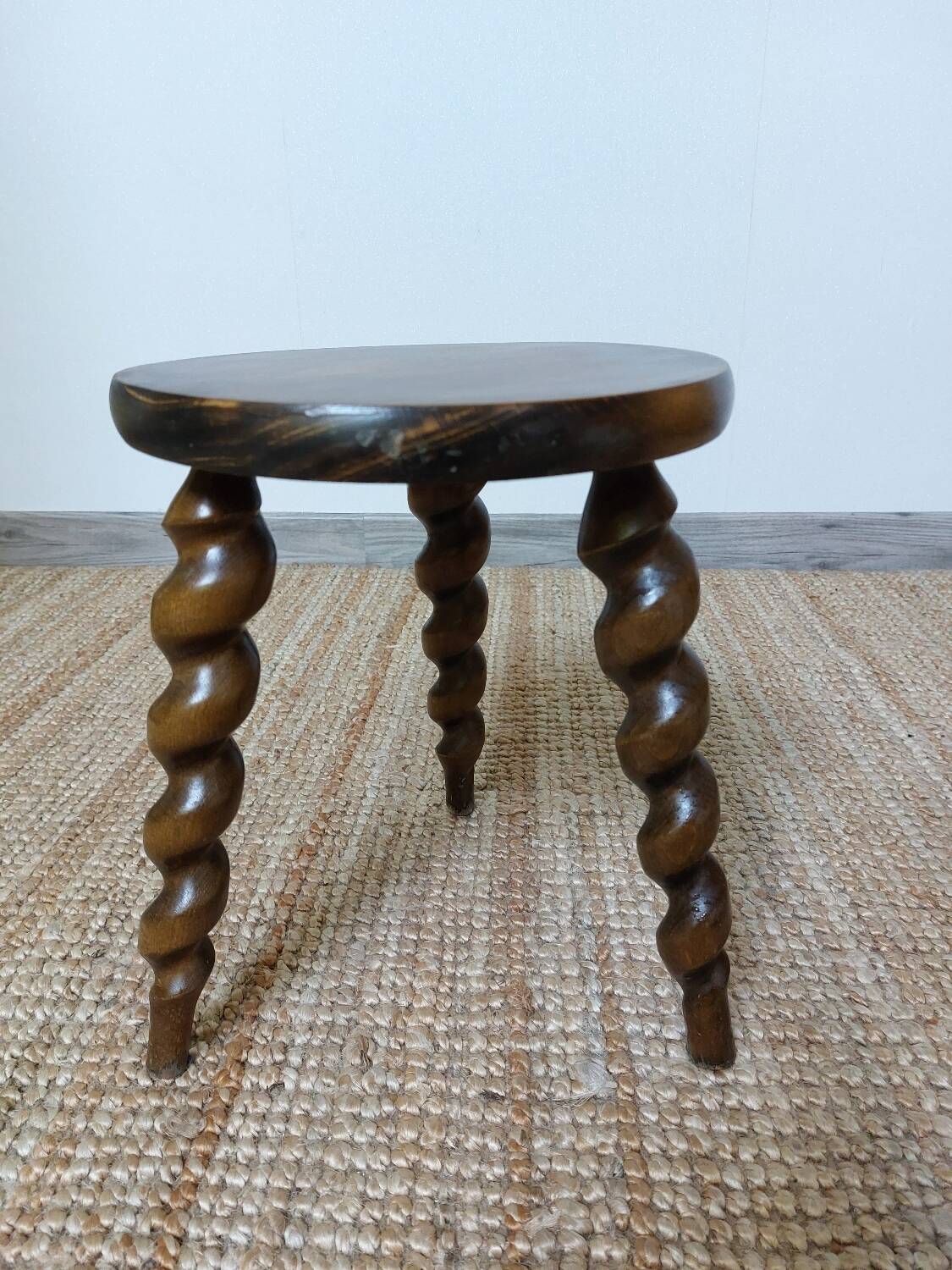 Wooden tripod stool with twisted legs