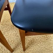 4 Scandinavian chairs in teak and black faux leather.