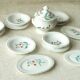 Tableware set in earthenware with floral decoration.