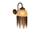 Wall lamp with marbled glass shade and beaded fringe in Art Nouveau style.