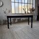 Oak farmhouse table with turned black legs.