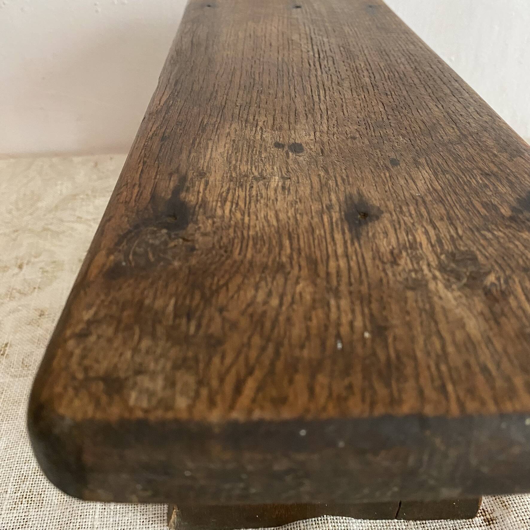 Old low stool made of solid wood