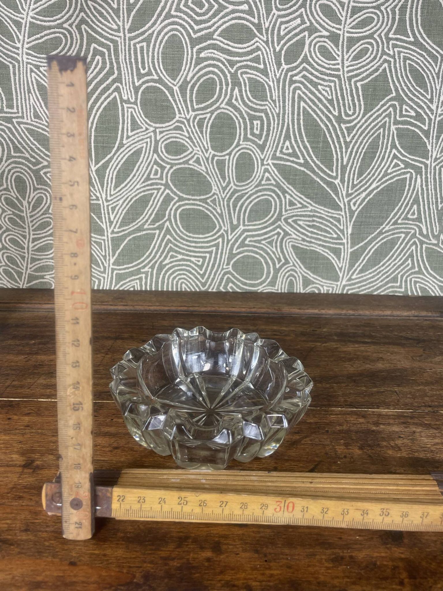 Vintage transparent glass ashtray with star decoration.