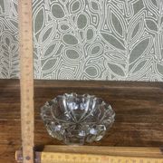 Vintage transparent glass ashtray with star decoration.