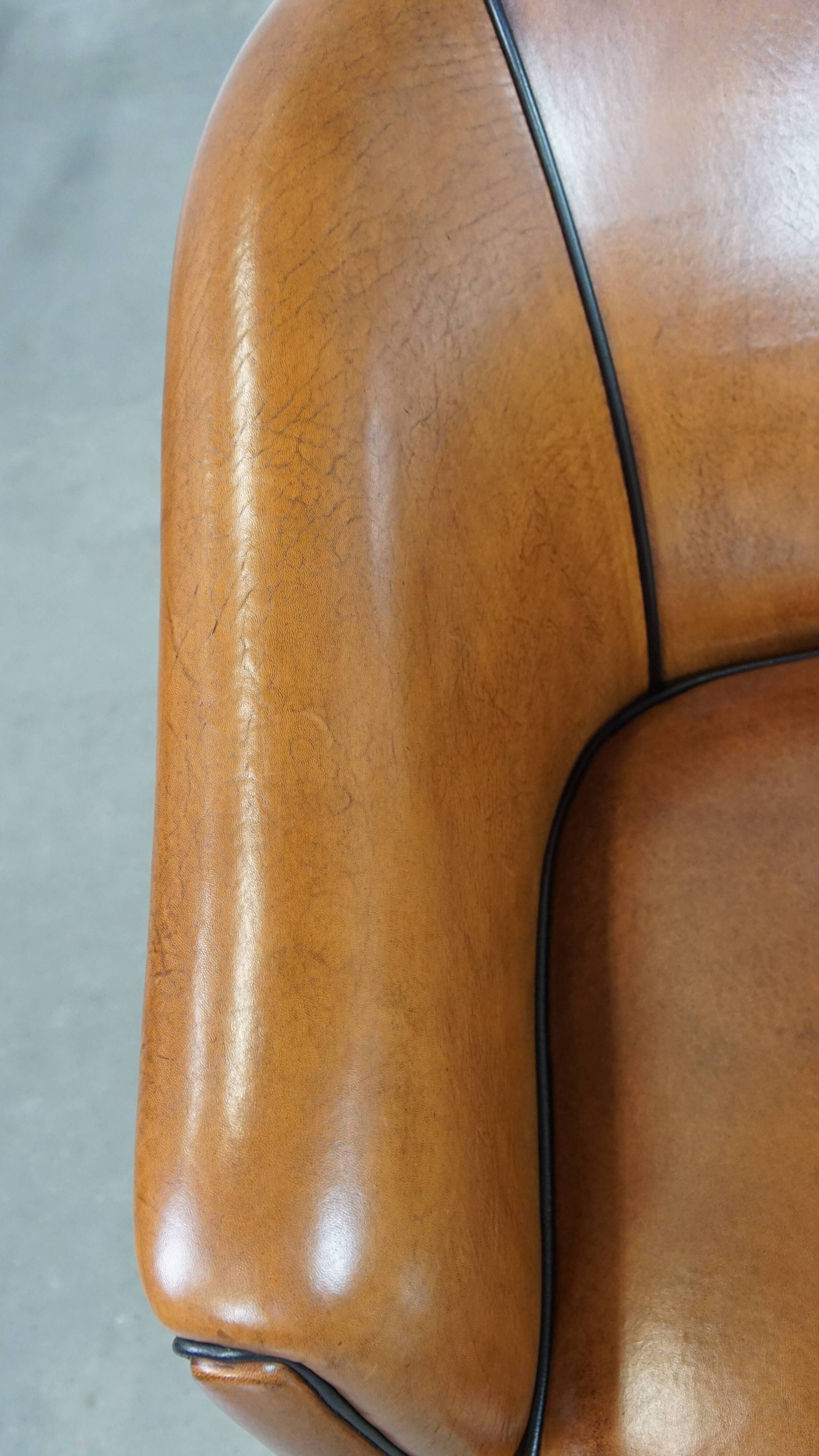 Sheep leather club chair finished with black piping