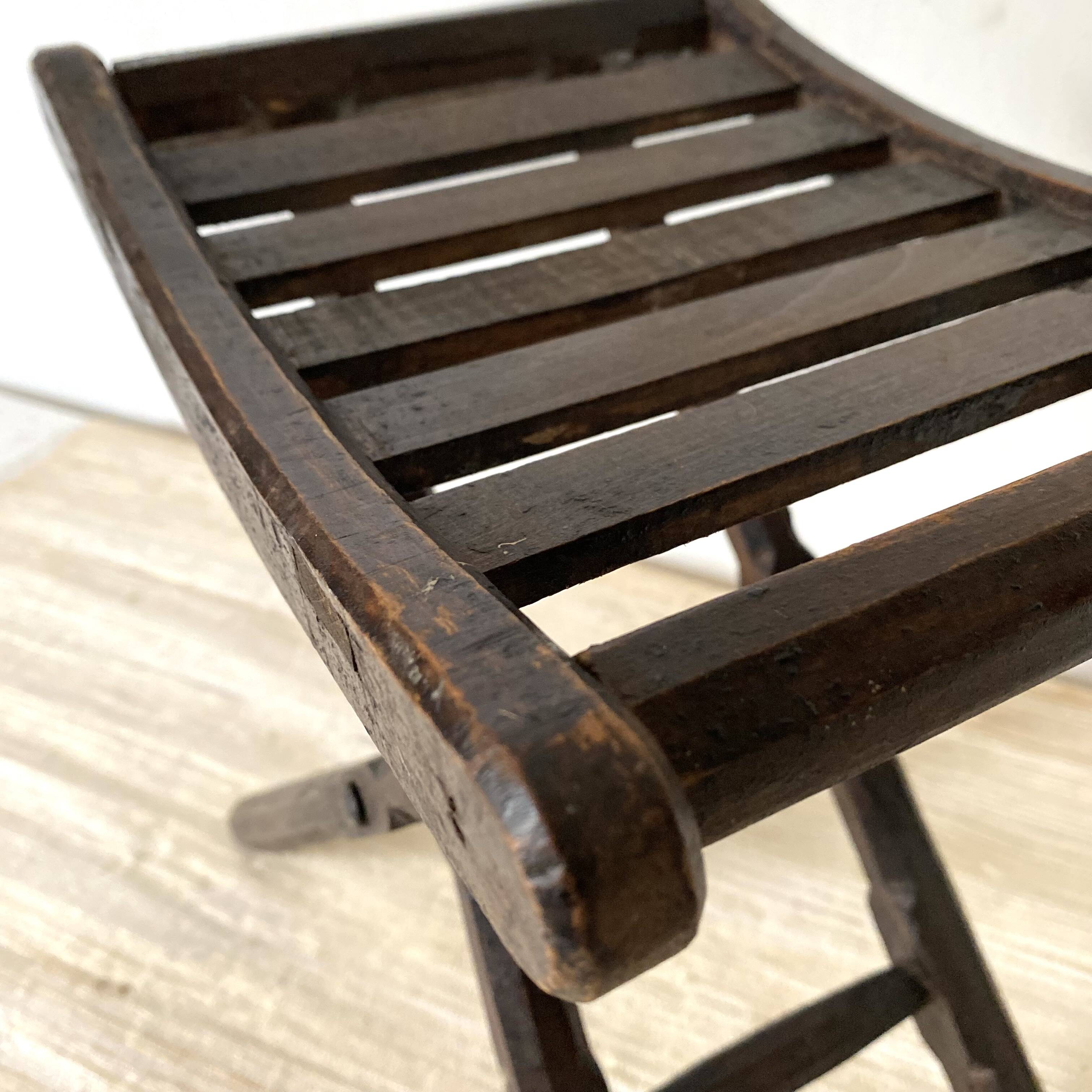 Folding slatted wooden stool