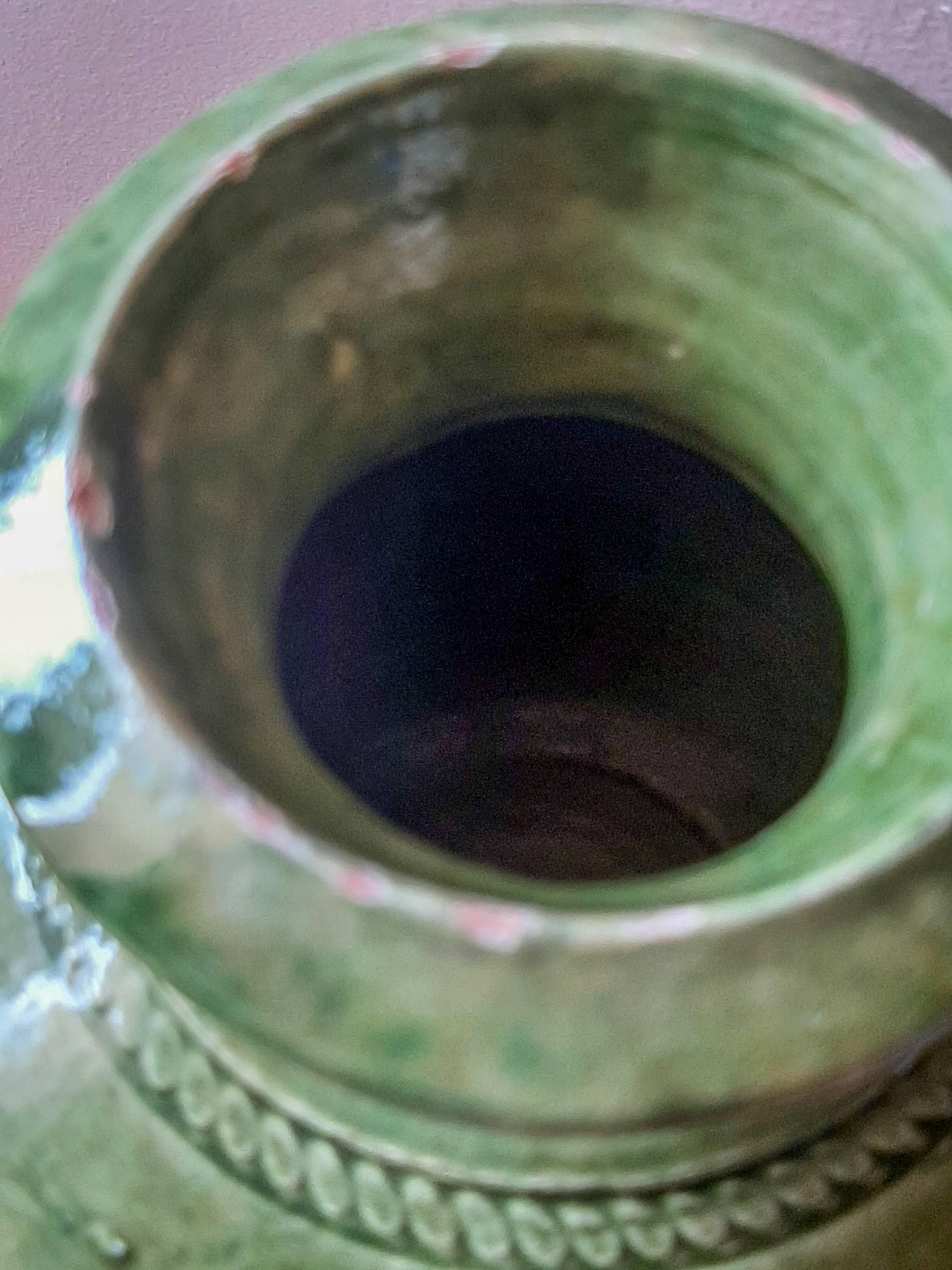 Ancient vase in glazed terracotta with green glaze.