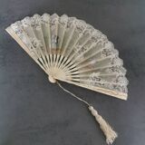 Old fan from the beginning of the 20th century with lace and painted decoration