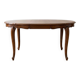 Round extendable dining table in Regency style made of cherry wood.