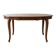 Round extendable dining table in Regency style made of cherry wood.