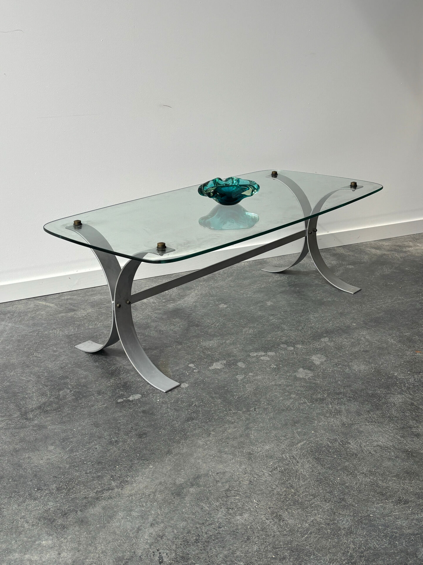 Design coffee table in brushed metal with a glass top, 1970s.