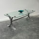 Design coffee table in brushed metal with a glass top, 1970s.