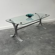Design coffee table in brushed metal with a glass top, 1970s.