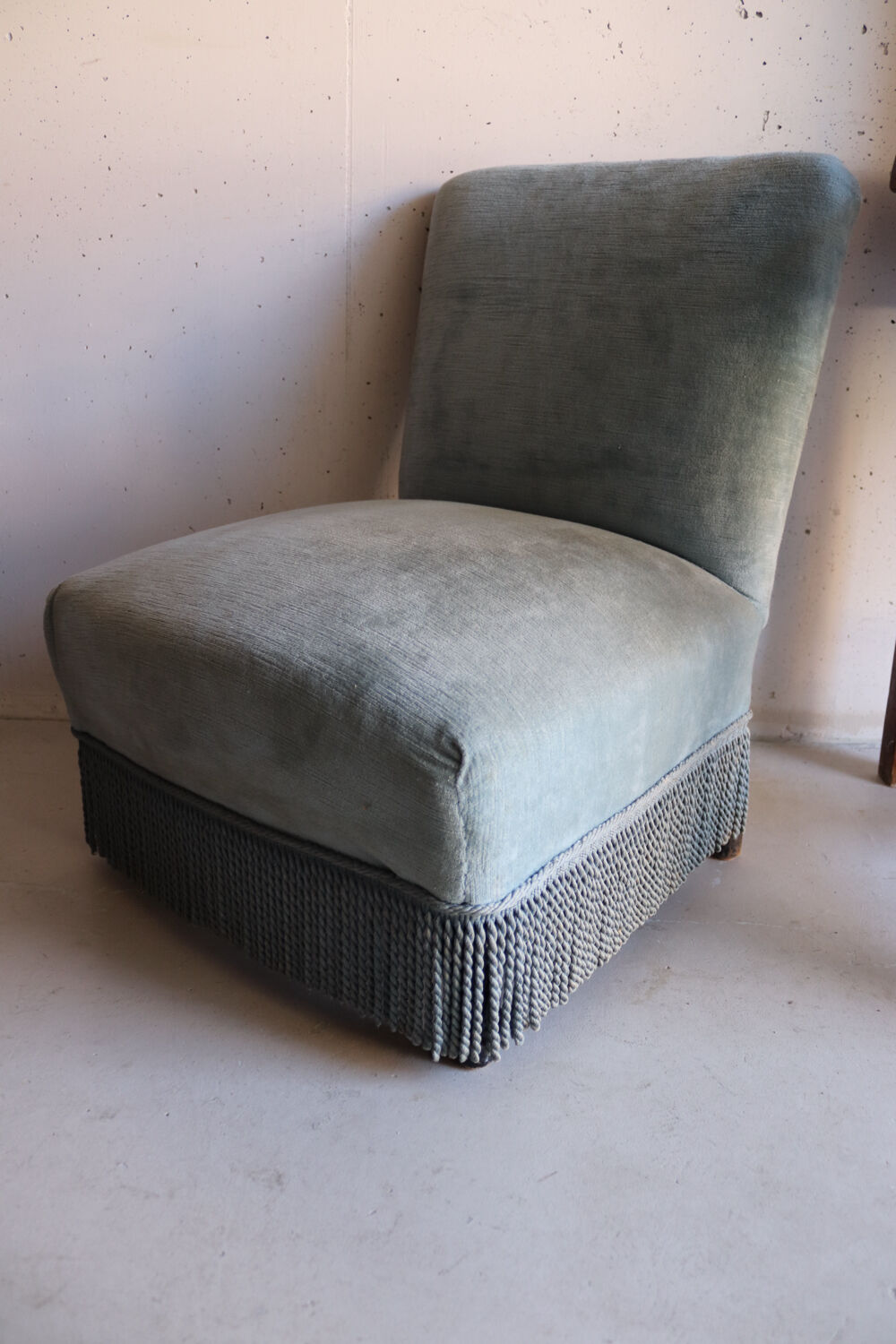 Vintage blue velvet fringed armchair.