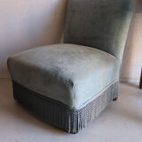 Vintage blue velvet fringed armchair.