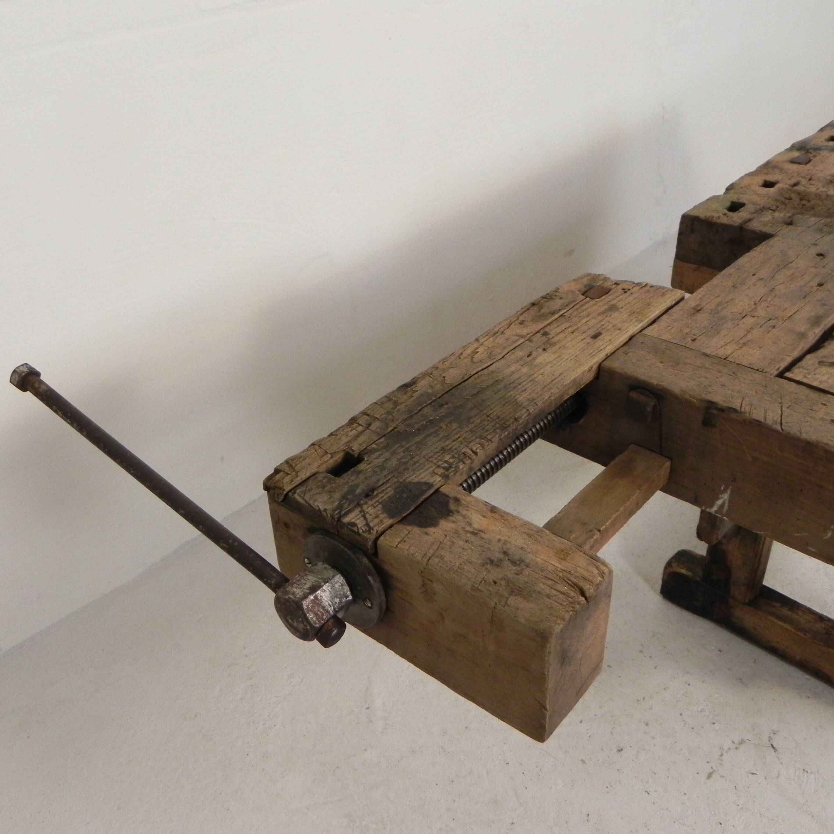 Wooden industrial workbench with vice, 194 cm long, 1930s.