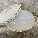 Old soup bowl with a golden border and decorated with small blue flowers