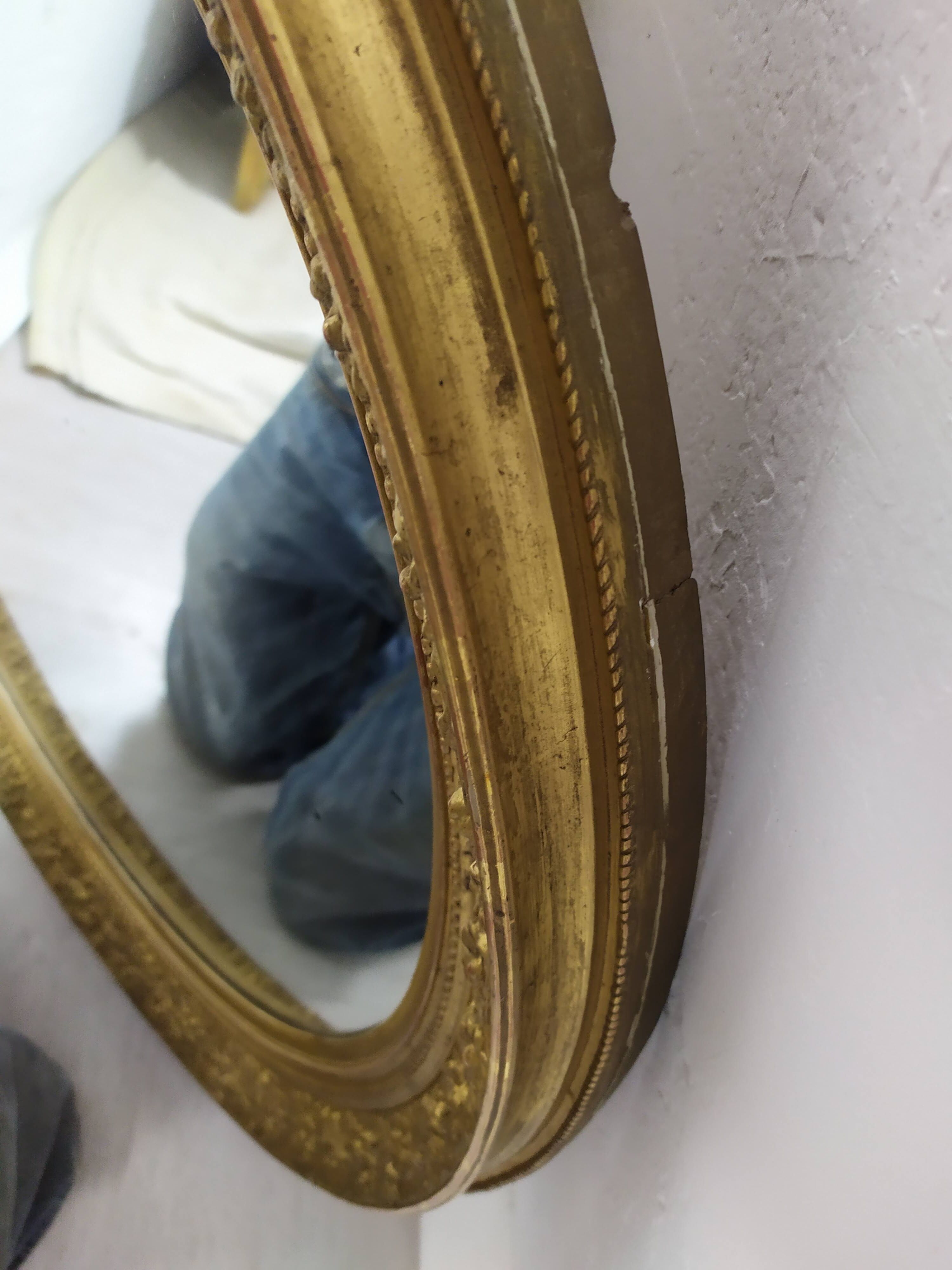 Golden oval mirror
