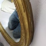Golden oval mirror