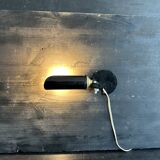 Old black metal and brass wall light, adjustable, 1930s.