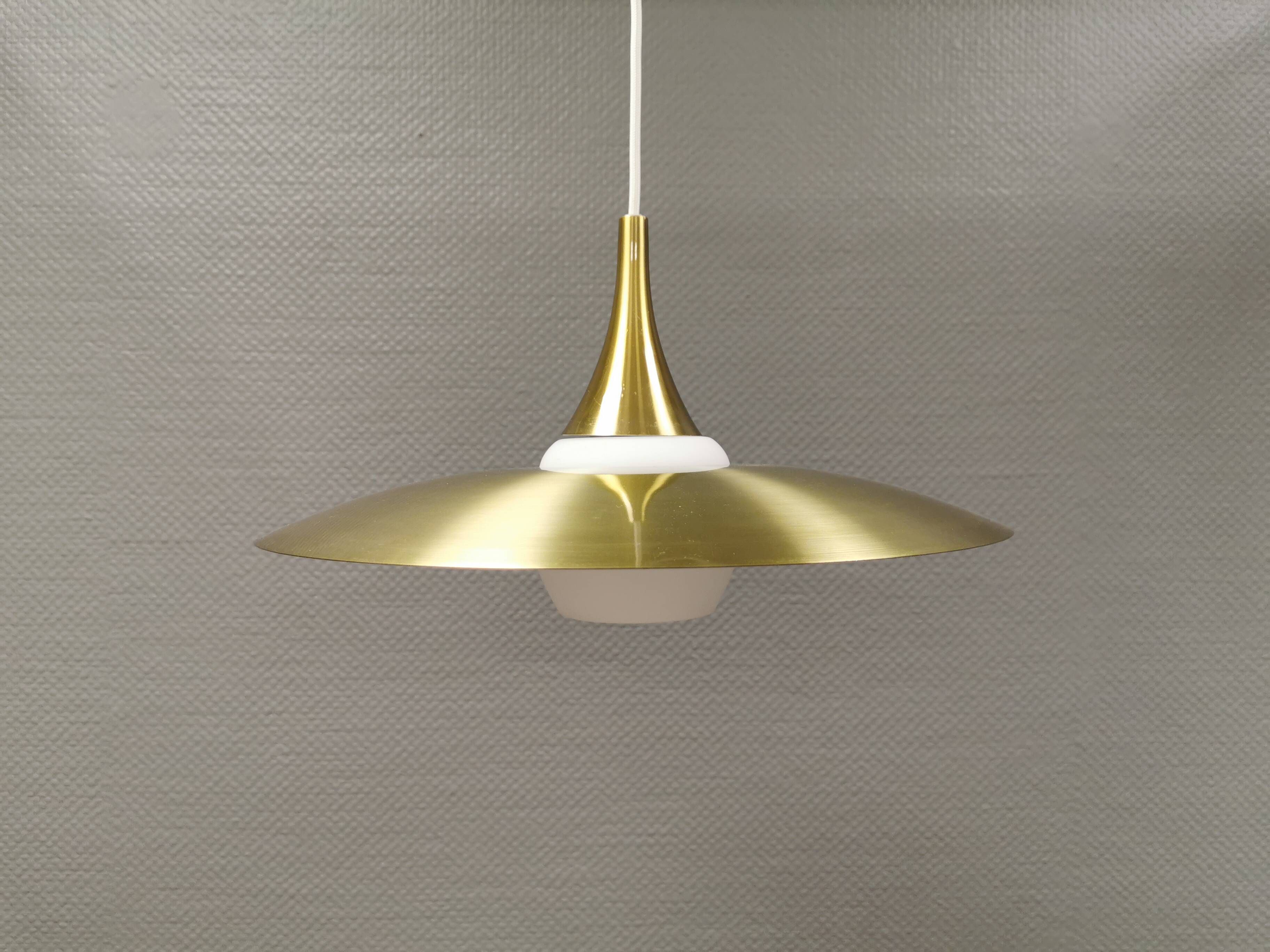 Hanging lamp, from the 1970s in matte white glass and brass colored metal.