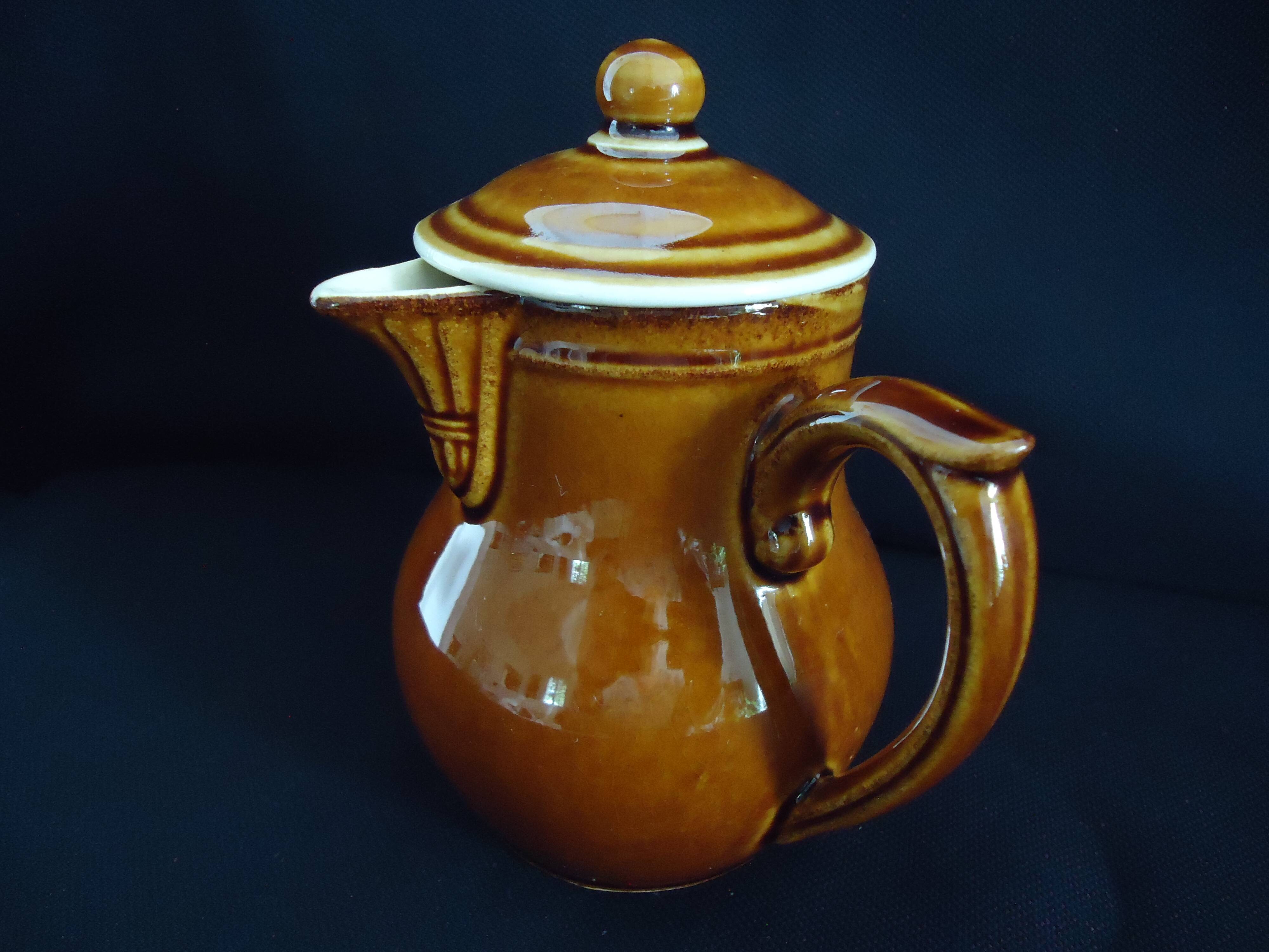 Old covered milk jug, side handle