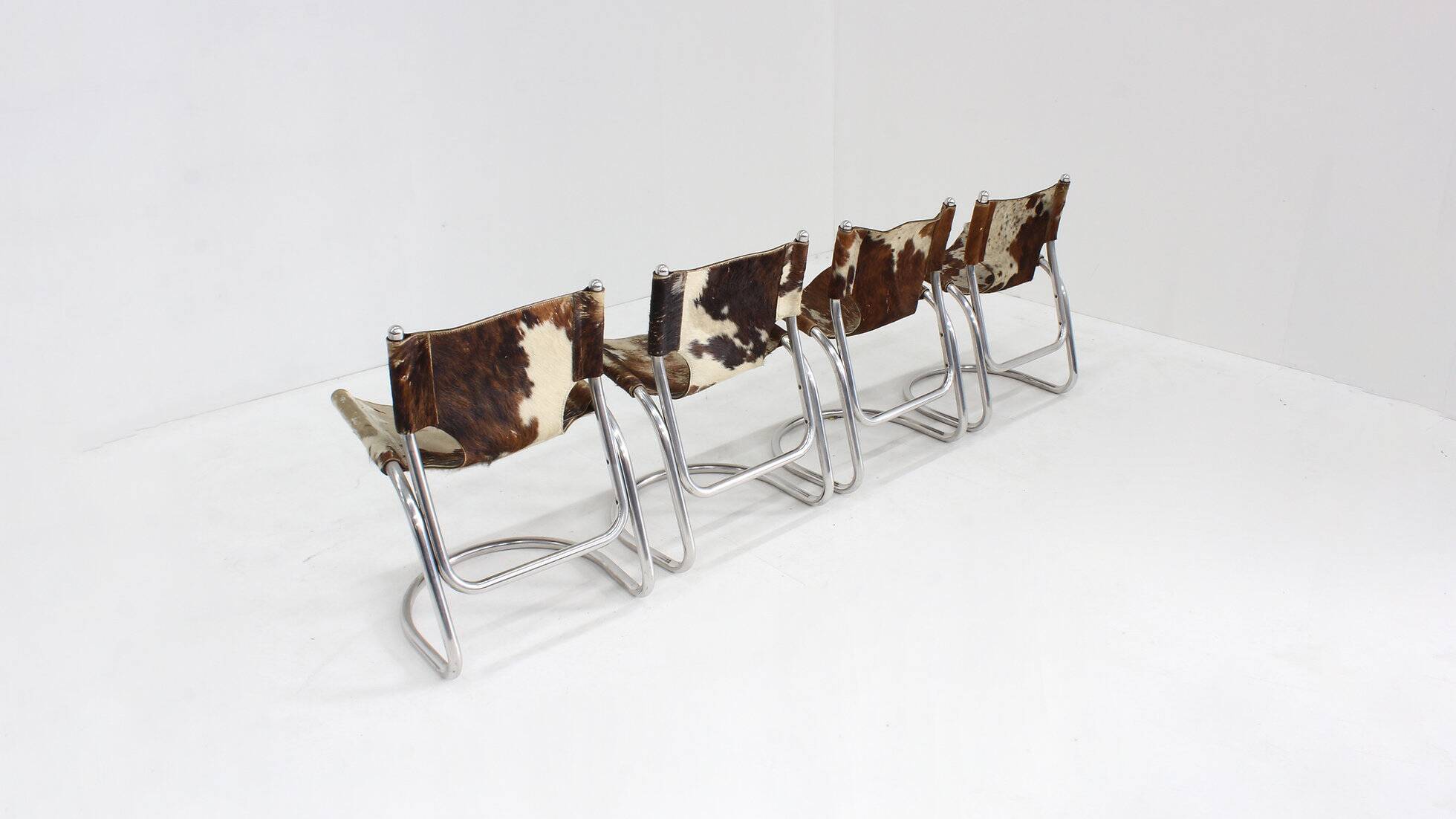 Vintage dining room chairs chrome and cowhide by Parravicini Fratelli