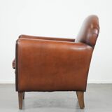 Sheepskin art deco design armchair with timeless and warm colours