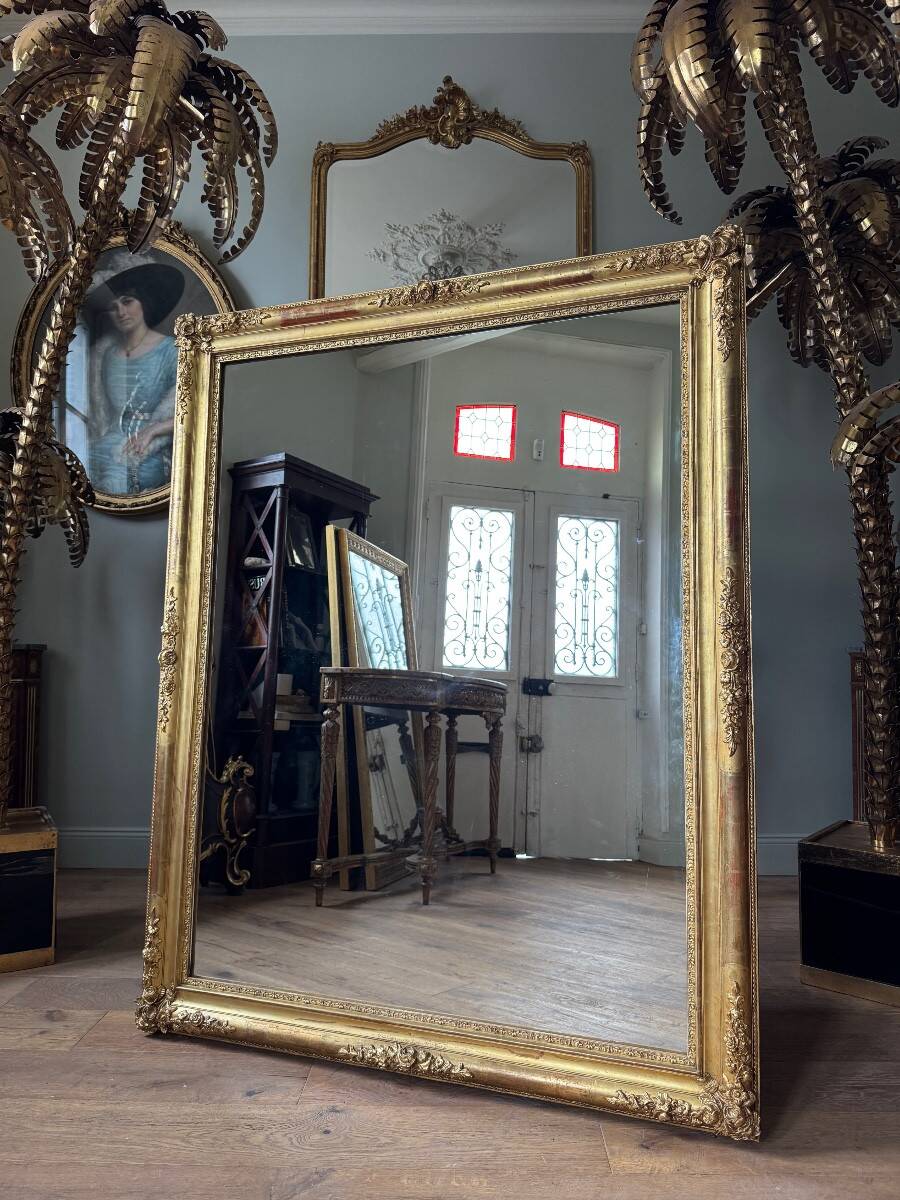 Restoration period mirror in gilded wood from the Napoleonic III era, 165 cm x 130 cm.