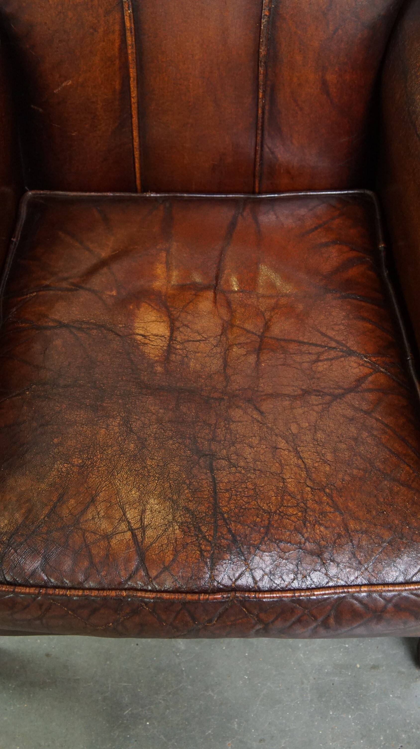 A vintage-style armchair with character, upholstered in beautifully patinated sheepskin.