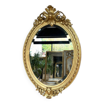 Antique mirror 102cm/69cm oval with pediments gilded with gold leaf from the late 19th early 20th century, beveled glass, parquet on the back.