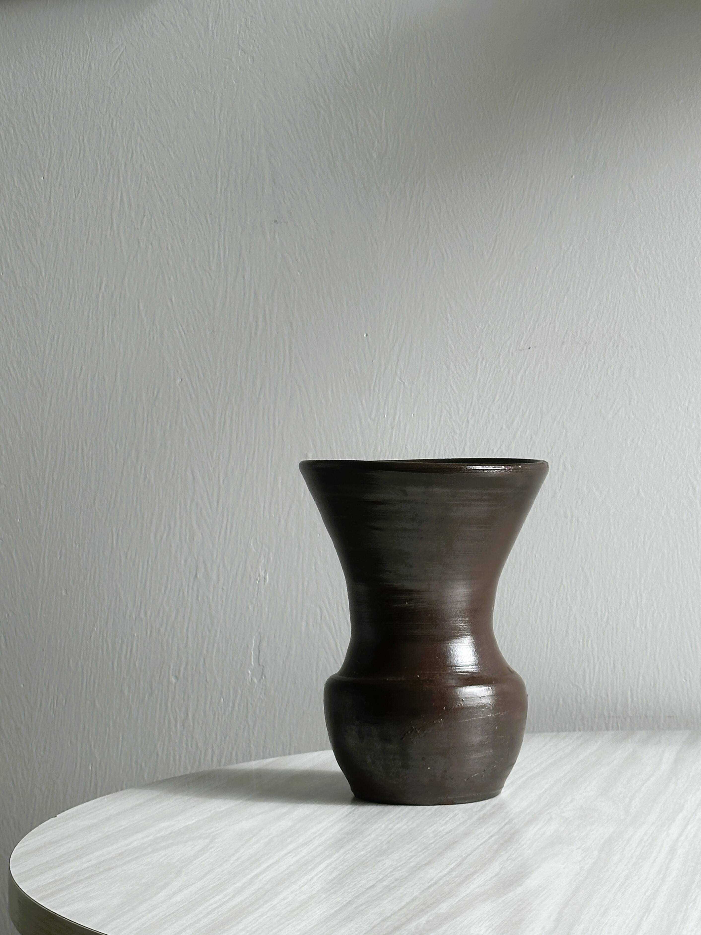 Dark brown ceramic vase, flared shape, smooth finish, classic style