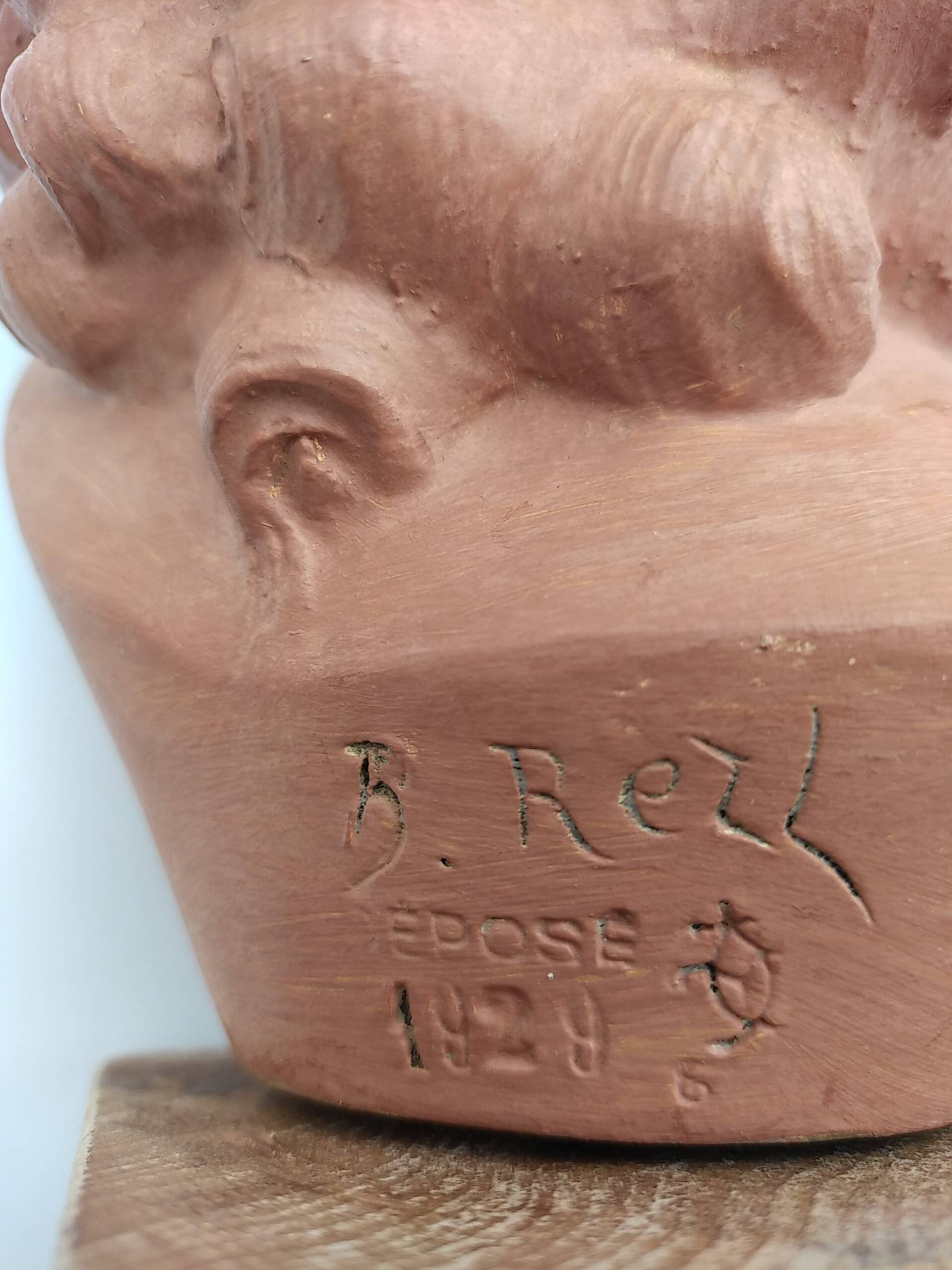 Bust young smiling girl. Circa 1900. Art Deco. Signed.