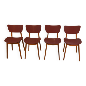 Set of 4 designer chairs in oak and red leatherette from the 1960s