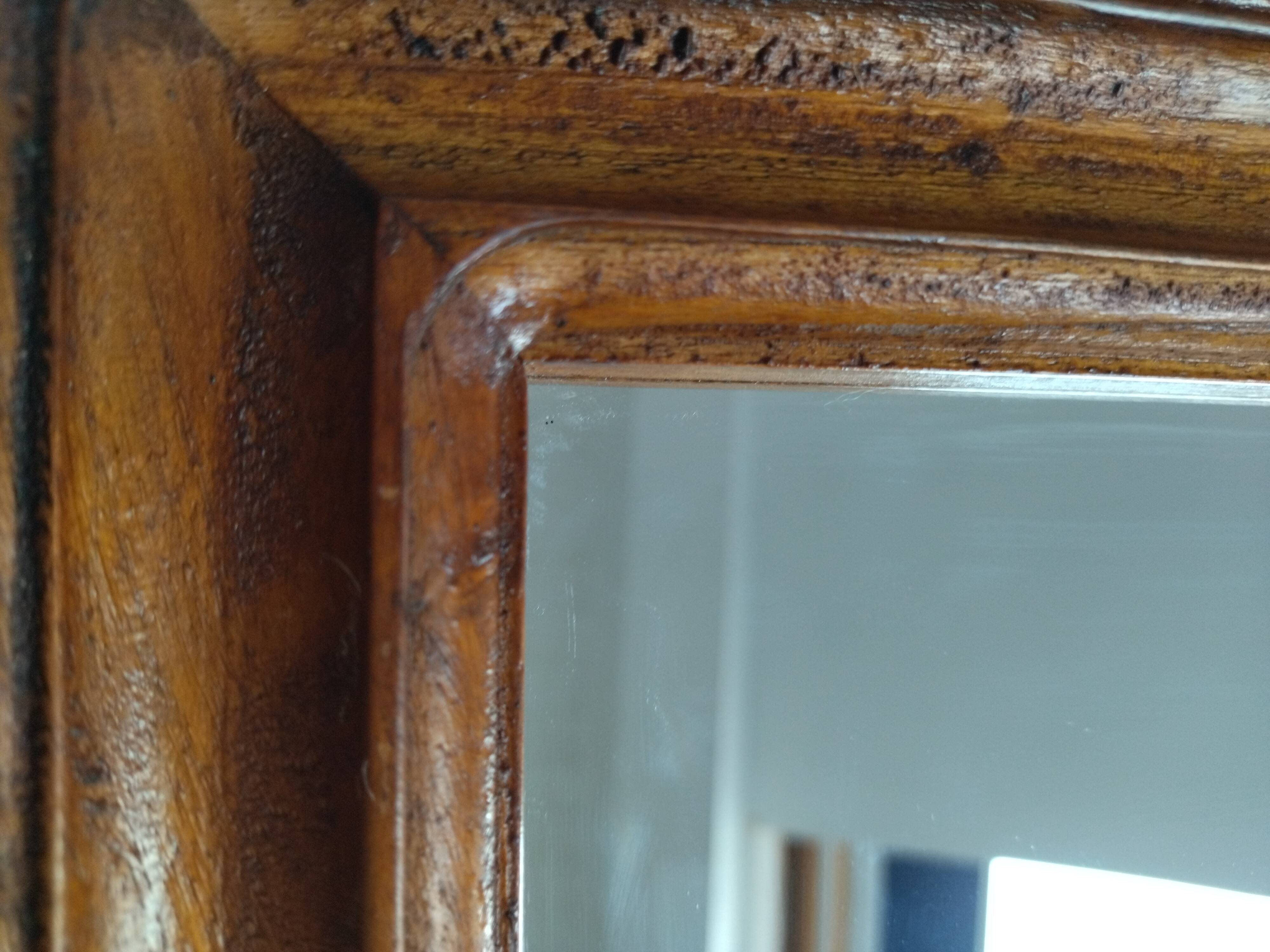 Wooden hanging mirror with vintage carved knot