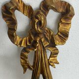 Bronze wall light, decorated with a bow and ribbon.