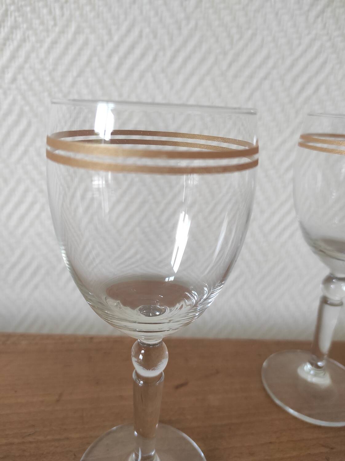 Set of 6 glasses with gold band decorations.