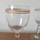 Set of 6 glasses with gold band decorations.